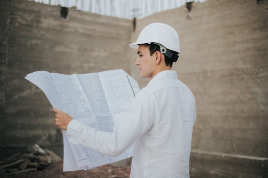 Architect examining blueprints at a construction site in Mexico.